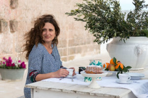 A woman doing breakfast in terrace at Masseria Potenti in Puglia Photographer Maria Teresa Furnari