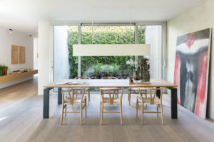 Wooden table in the living room of the concrete and minimalist villa of Rosalba Piccinni Photographer Maria Teresa Furnari