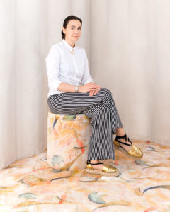 Portrait of the designer Cristina Celestino on Sabaitalia sofa at Brera Design Apartment Photography of Maria Teresa Furnari